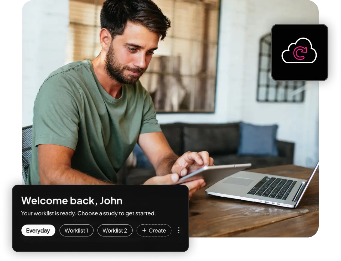 Man seated at a desk using a tablet beside an open laptop in a home or office setting. A dark user interface overlay reads “Welcome back, John. Your worklist is ready,” with options for Everyday and multiple worklists, while a cloud sync icon appears in the corner, suggesting a digital worklist or radiology workflow application.
